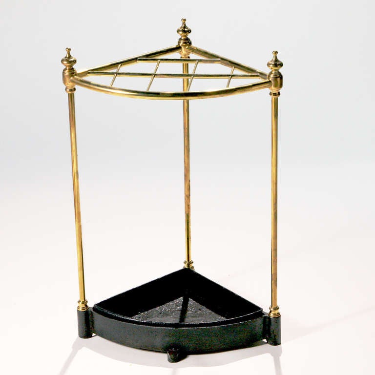 Rare triangular-shaped antique English brass stick stand. Perfect for a corner space! Original removable black metal drip tray.