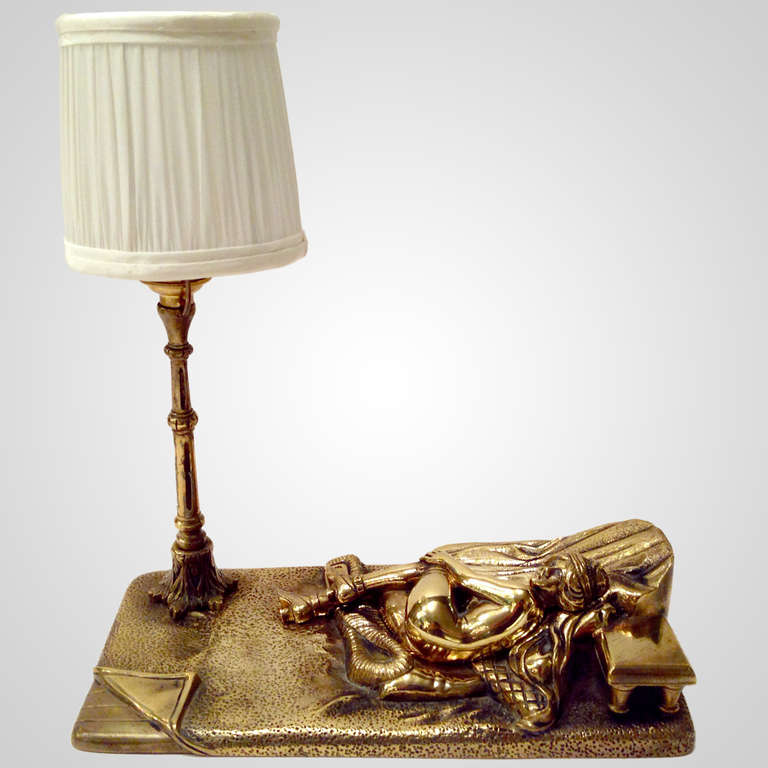 Charming miniature brass boudoir or accent lamp. Harem motif with female nude reclining on pillows and throws. A connoisseur's piece!