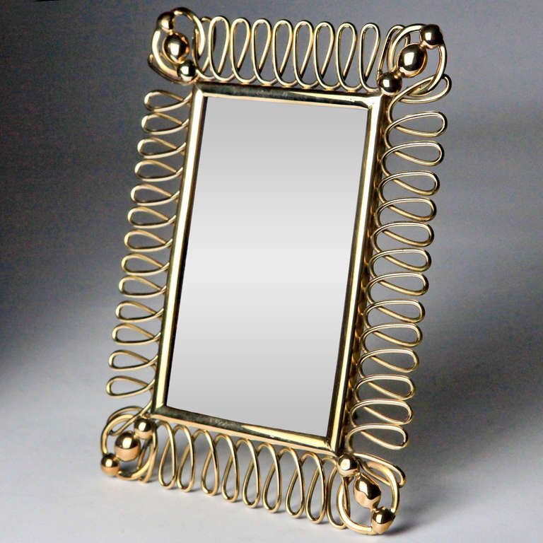 Victorian brass ring picture frame with large narrow circles with brass button corners.