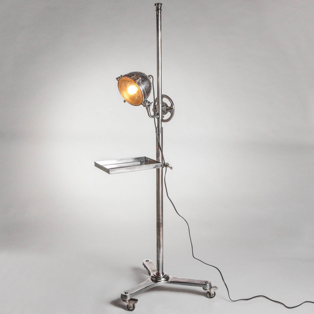 Unique standing adjustable lamp with small rectangular side tray on a tripod base with wheels. Limited edition; one available.