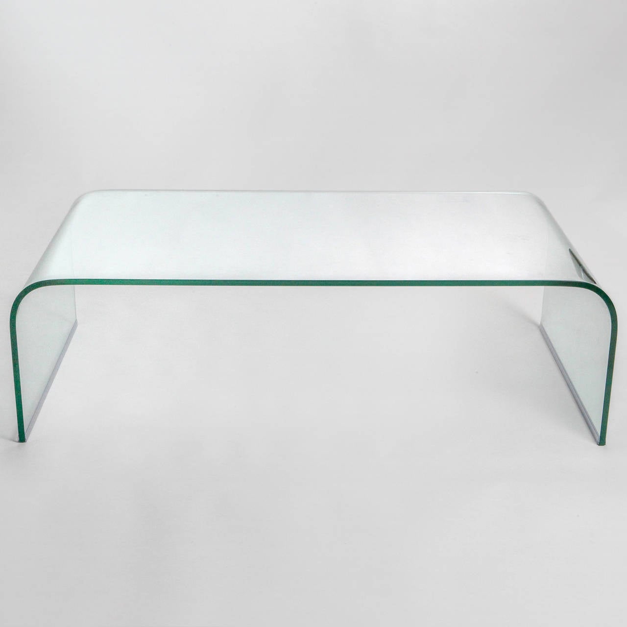 Sleek glass coffee table with Classic curved sides.