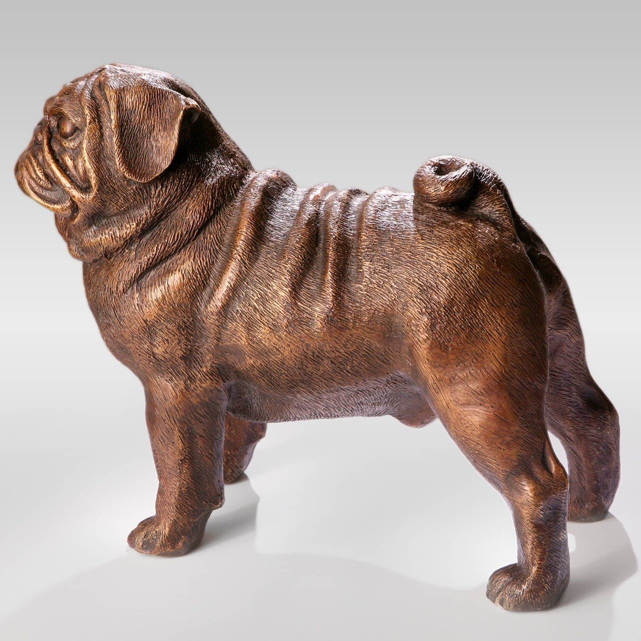 Small standing cast bronze pug dog figure. Exclusive design.