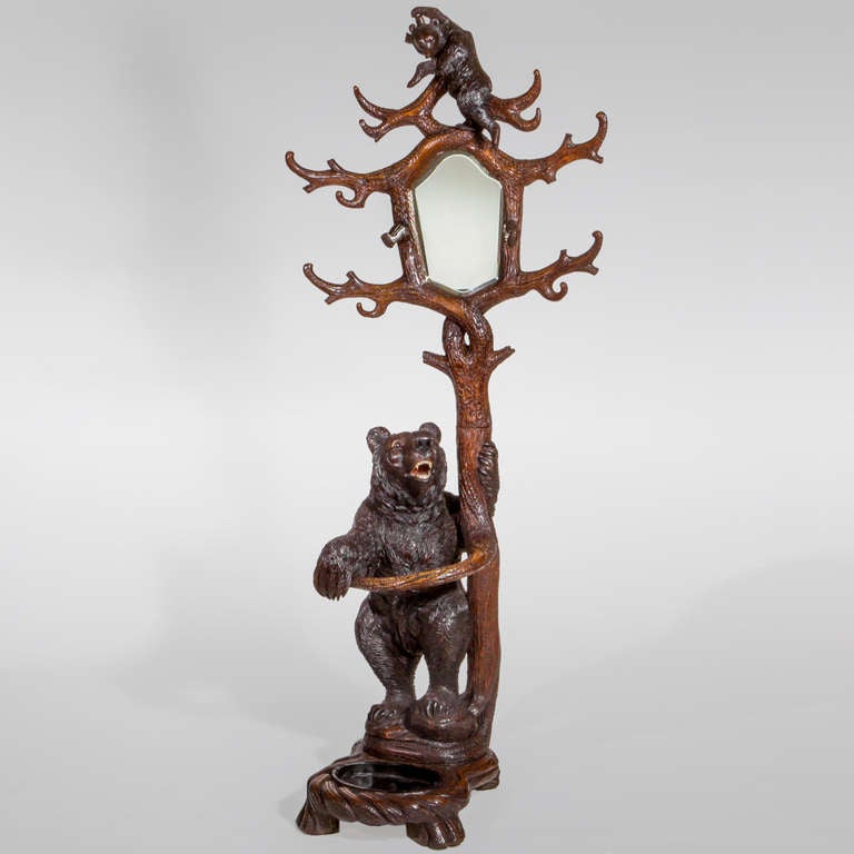 Large carved hardwood Black Forest bear hall stand. Whimsical design with exceptional detail. The large mother bear stands at the base of the tree while the bear cub is at the top among branches that encircle a mirror.
