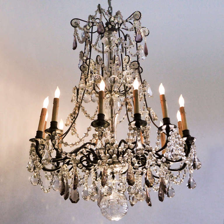 Magnificent 19th century French crystal chandelier with 12 candle arms. Draped with large size crystal bead roping, heavy pear shaped drops and facetted violet tone smoky crystals. Electrified.
