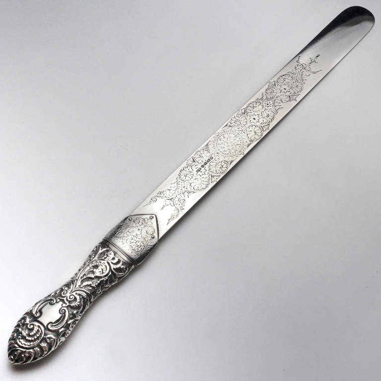 Exceptional Victorian silver page turner the repousse silver handle with center medallion and swirl pattern the blade etched on both sides with an intricate flower and leaf design. Hallmarked: George R. Unite of Birmingham, circa 1886-1887. George