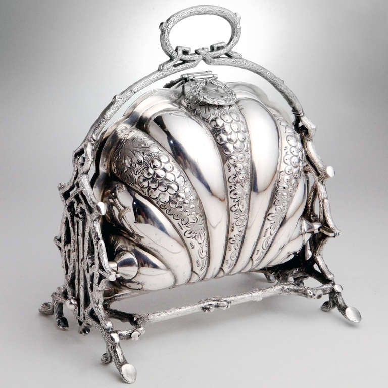 Ornate Victorian silver plated mechanical toast or bun warmer with graceful shell design. Excellent detail, the frame with a curved branch motif and circular handle, the interior with vented pierced toast holders, all on raised branch legs.
