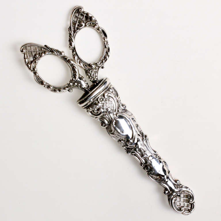 Antique Edwardian silver scissors in repousse sheath.  Desk scissors with intricate detail in scroll, flower and lattice work patterns.  Hallmarked: Levi & Salaman, Birmingham, England, 1907-10.