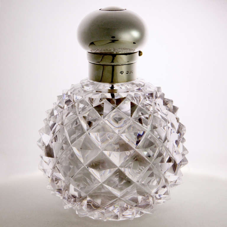Important Edwardian sterling silver mounted heavy cut crystal perfume atomizer in a rare large size. The crystal cut in the traditional spiky pineapple pattern. The hallmarked silver mount with dome shaped top with center atomizer spray button.