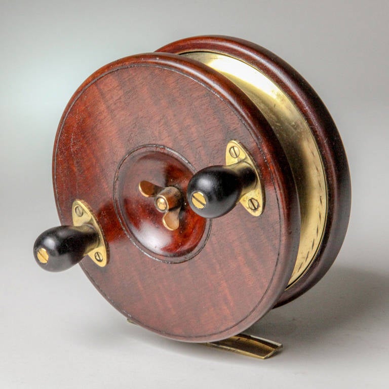 English star back wooden fishing reel with brass fittings.