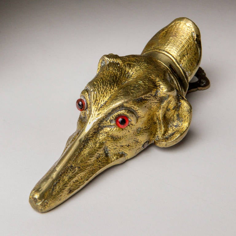 Antique English gilded brass paper clip shaped like a dog head.