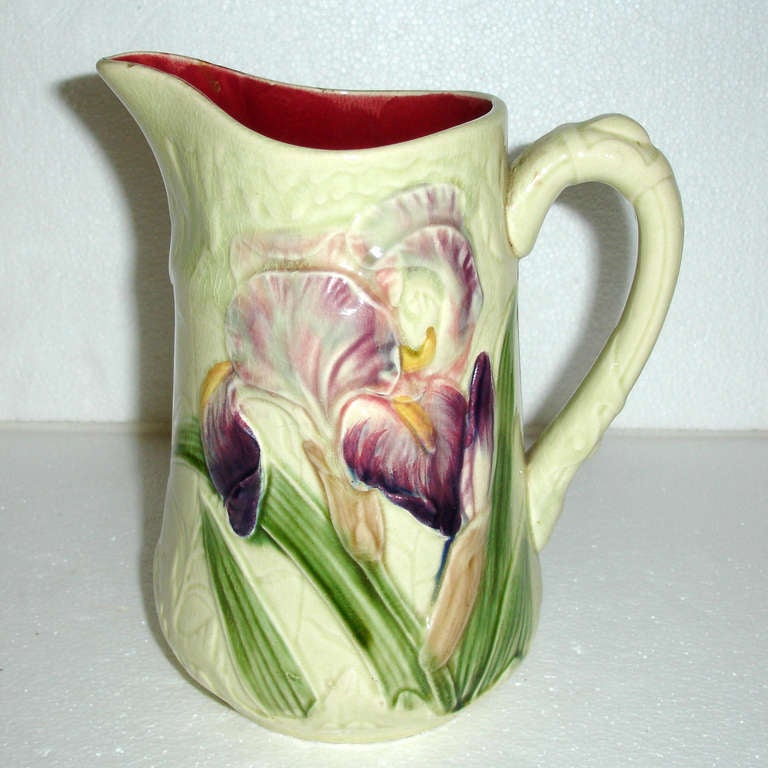 Large French Majolica pitcher. Purple iris flower with green leaves on a crème background. Interior a deep burgundy color. Signed and numbered: Choisy Le Roi, France, circa 1900.