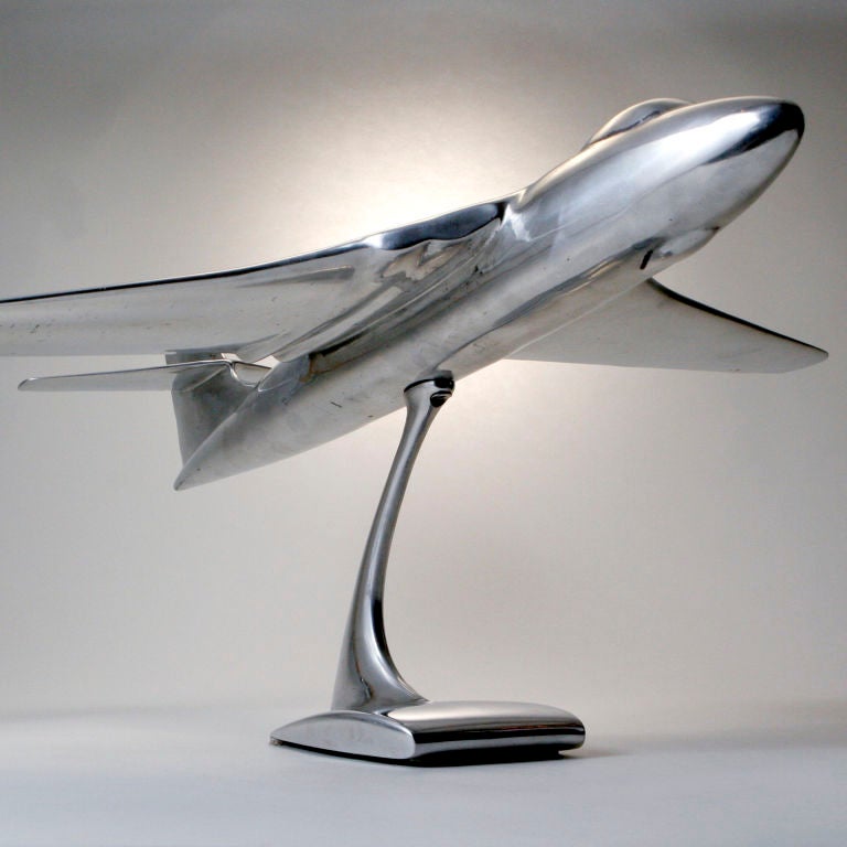 Large polished cast-aluminum model jet on stand used for desk display.
