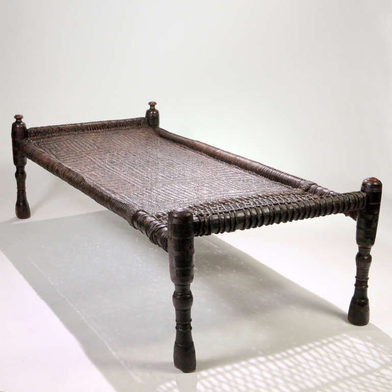 Hand-made traditional Swahili designed African wedding bed.  This platform or daybed with a combination of woven box pattern matting and open weaving on hand carved hardwood legs.  Because of low height and long rectangular shape, these beds make