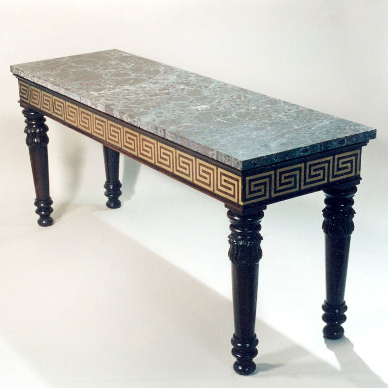 Long mahogany console table with rouge Violette Italian marble top. Features inlaid table apron with brass Greek key pattern, hidden drawer and ring-turned legs with leaf carvings.