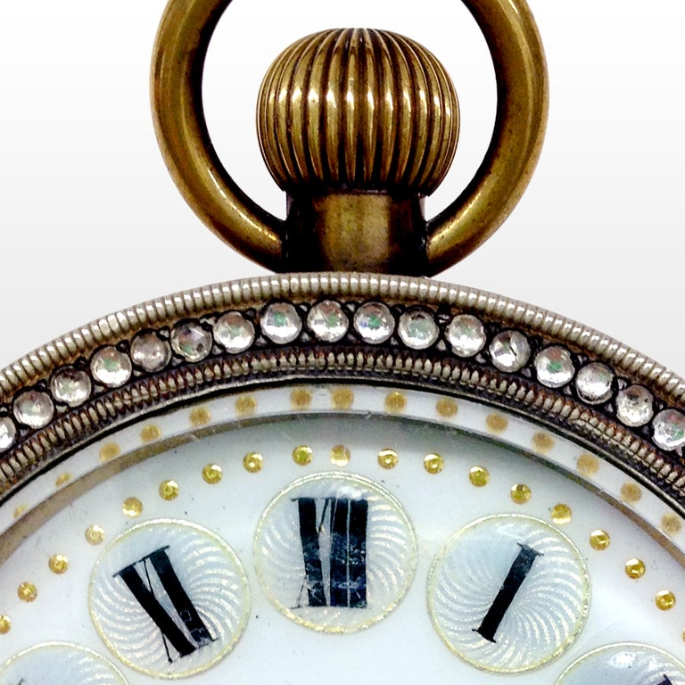 Beautiful European diamante glass ball clock with small clear paste stones set into a bronze case. The enameled face with black Roman numerals on polished mother-of-pearl circles outlined in gold. Small gold accents to the clock face.