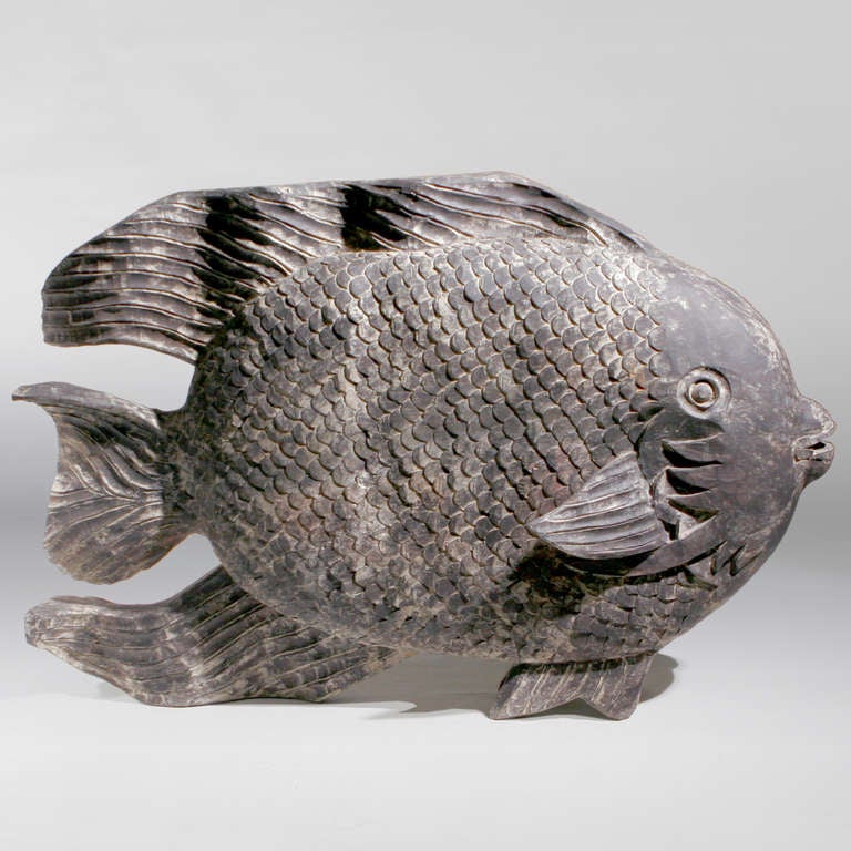 Decorative angel fish with undulating fins and delicately textured scales. Created in carved wood with a weathered patina. One of a series of carved wood fish in approximate two-foot, three-foot, and four-foot sizes. This one in medium three-foot