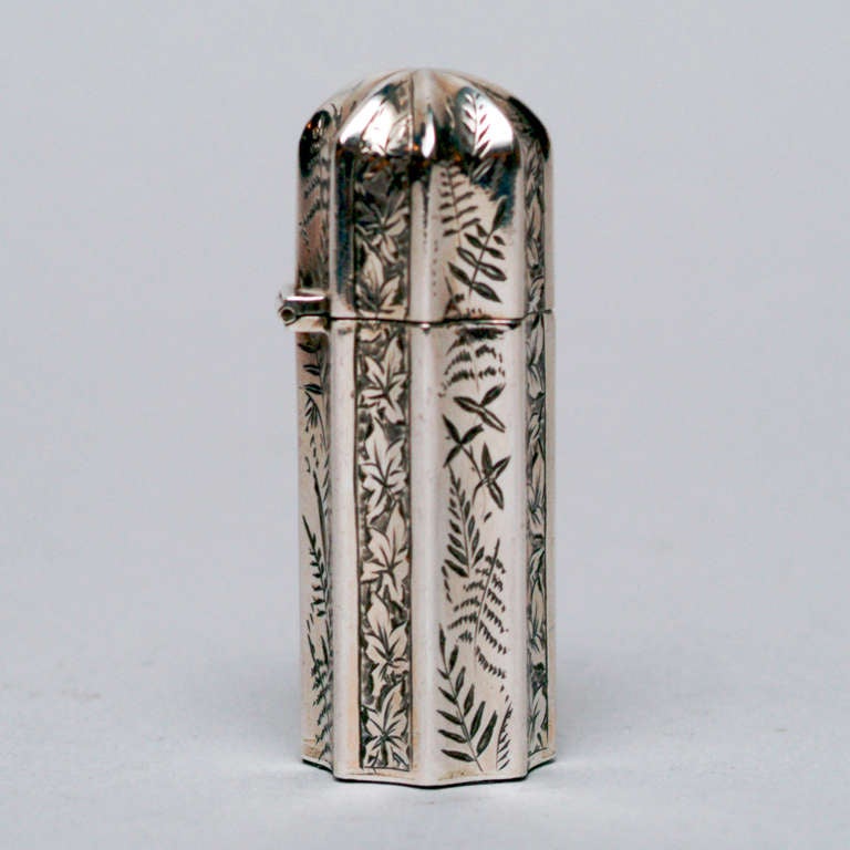 Small sterling silver travel perfume bottle with etched fern design, fitted with interior glass jar.  Hallmarked: Chester, England 1888.