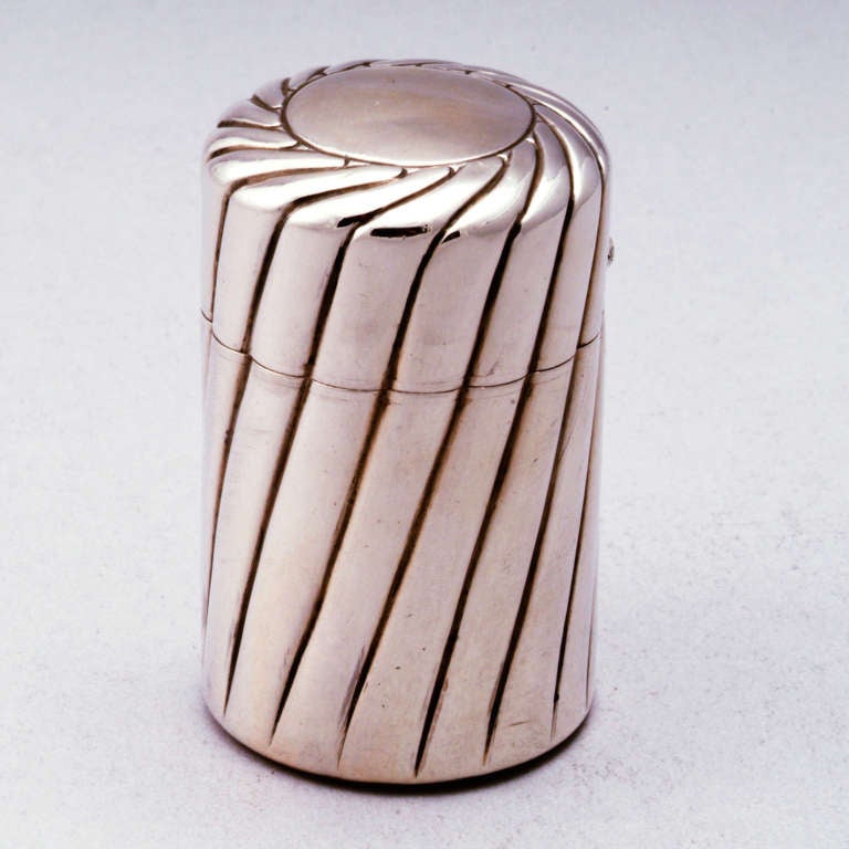 Substantial travel sterling silver scent bottle in traditional ribbed pattern. Fitted glass interior with original stopper. Smooth silver top perfect for monogramming. Hallmarked: Birmingham, 1889.