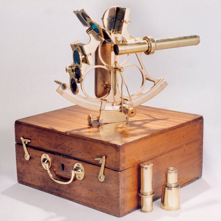 Turn-of-the-century brass astronomical measuring instrument used to determine latitude and longitude at sea.  Multiple parts include telescope and colored glass filters along with wood storage case.