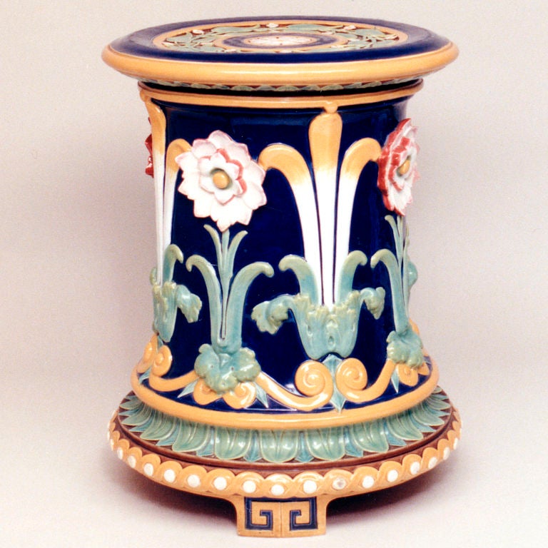 Early majolica garden seat with stylized fleur-de-lys flowers on cobalt blue ground, raised on small key pattern feet. Signed: Minton.  Pattern #982.  Date Code: 1877.