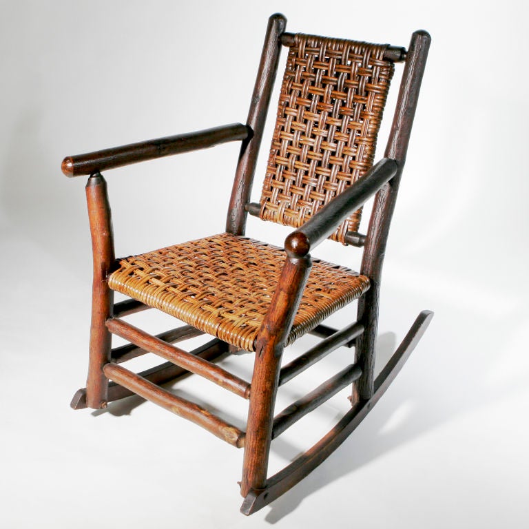 Vintage hickory wood rocking chair from the Old Hickory Company of Martinsville, Indiana.  The joining is doweled and coned.  This Adirondack rocker is typical of the style as seen at the Old Faithful Inn of Yellowstone Park and Adirondack camps of