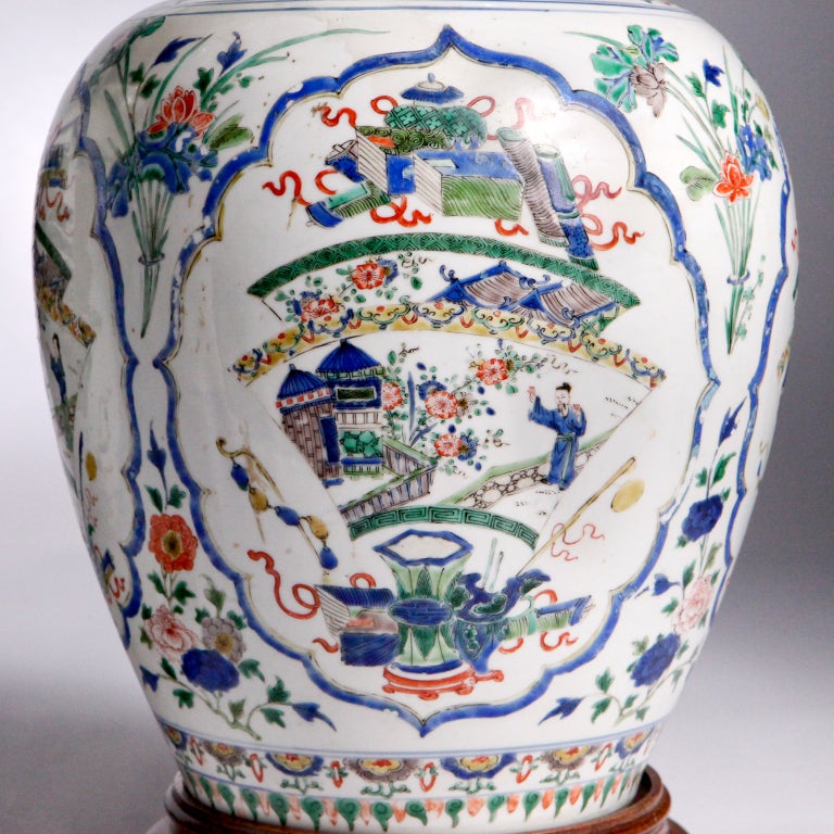 Pair of substantial Oriental ginger jar lamps painted with excellent detail.  The sides with blue banding which outlines large medallions depicting Far Eastern garden scenes.  The bases with round fitted wooden stands.  