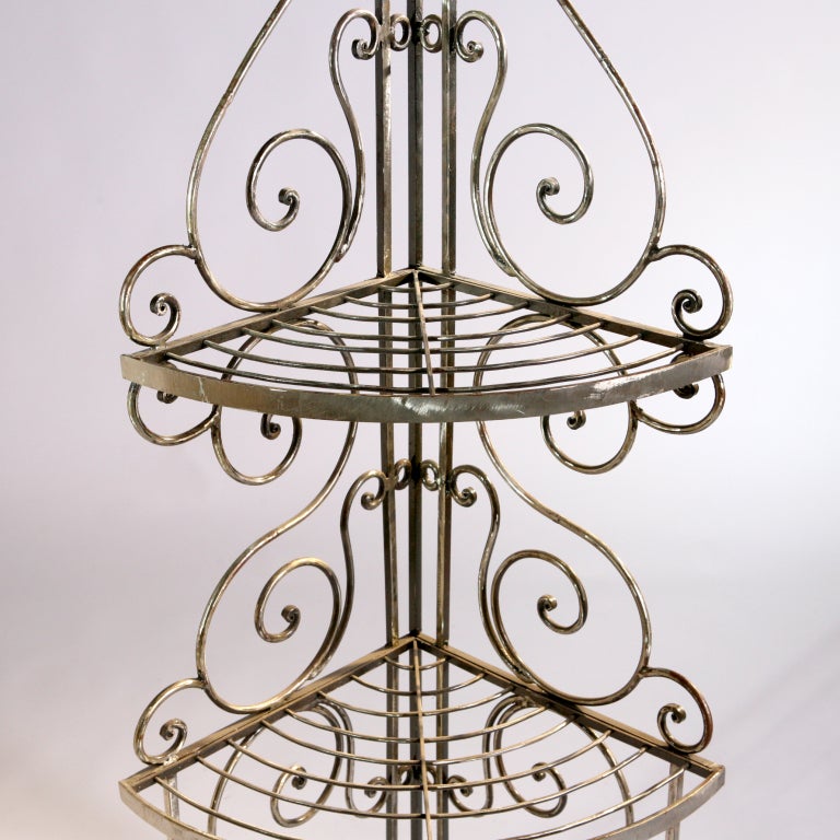 Four-tier French corner iron baker's rack.  Traditionally detailed with scroll work.  Two available.