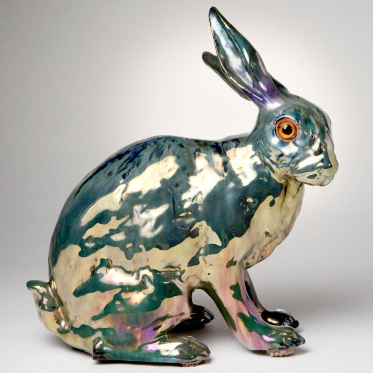 Rare English Victorian Sunderland lustreware rabbit with a green, gold and black metallic finish. Large seated rabbit with long ears and glass eyes - the body with amazing colors in a high metallic sheen from the oxides added to the glaze.