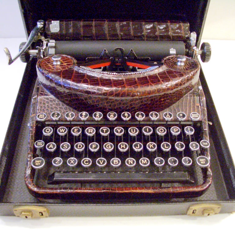A rare antique travel typewriter; the body completely covered in vintage brown crocodile. The typewriter itself is a Remington portable - RNP - made for the European market in the late 1930s. The size typical of a traditional travel model at 5