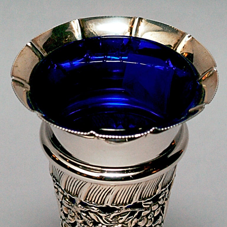Ornate turn-of-the-century hallmarked silver vase with floral motif and cobalt blue glass insert.  Hallmarked: Birmingham, 1900.