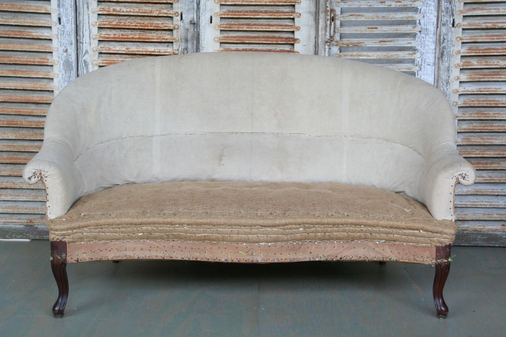 Small French settee, made around 1880, with Louis XV style legs, stripped down to muslin and burlap.