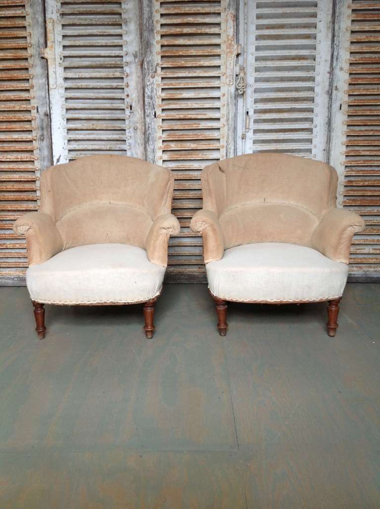 Pair of Napoleon III armchairs with rounded backs in muslin. This pair is sold in as is condition.