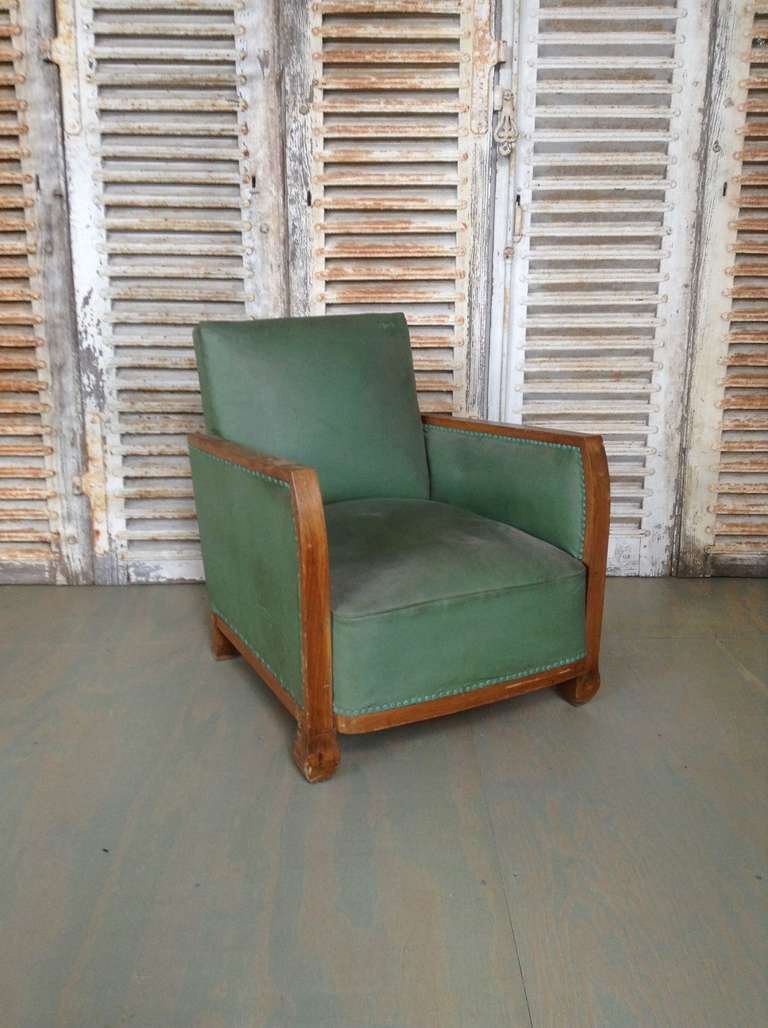 French 1930s armchair with mahogany trim and original green vinyl. This piece is sold in 