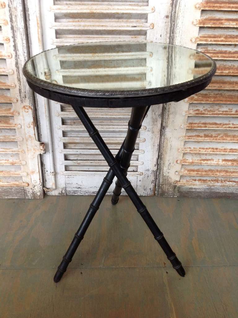 French Napoleon III black faux bamboo end table with tripod legs with mirrored top.
Measures: 29