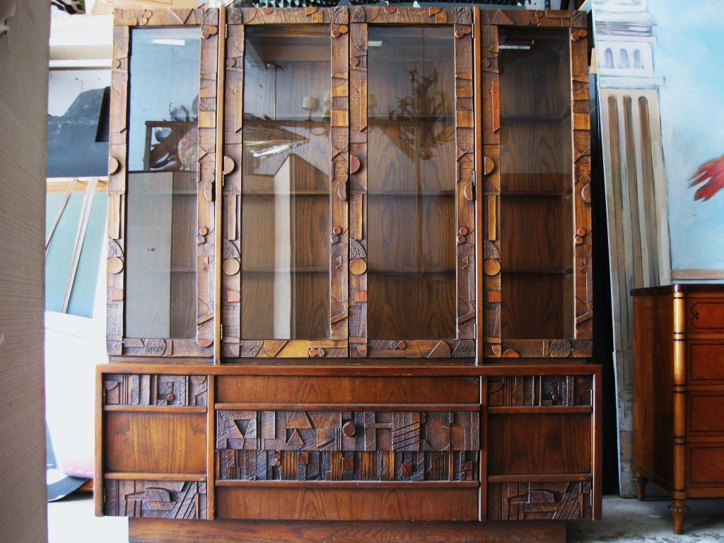 Spectacular 2 piece cubiste / brutalist inpired by Nevlson, breakfront. Wonderful as bookcase, display, sideboard, has 2 drawers on the bottom, 2 adjacent doors and 4 glass panels on top with two central doors. This particular cabinet is in very