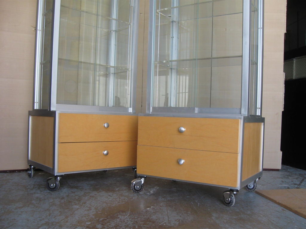 Tight pair of Display cabinets, wood, stainless steel, glass and lucite on high tech wheels. Wonderful to display objects, #jewelry, in a boutique, store, living room, bathrrom, showroom. Have two dresser drawers each on bottom, for storage. Good
