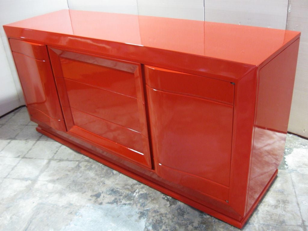 Superb French 40's cabinet, sideboard, large dresser, chest, lacquered in a rich high gloss red lacquer. Elegant slightly curvacious lines, 3 center drawers, 3 side drawers,two doors, one on eacg side. Wonderful with antique, periord furniture or