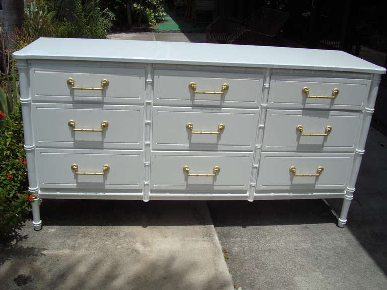 Newly lacquered white gloss 9 drawer dresser with gold leaf pulls.

64