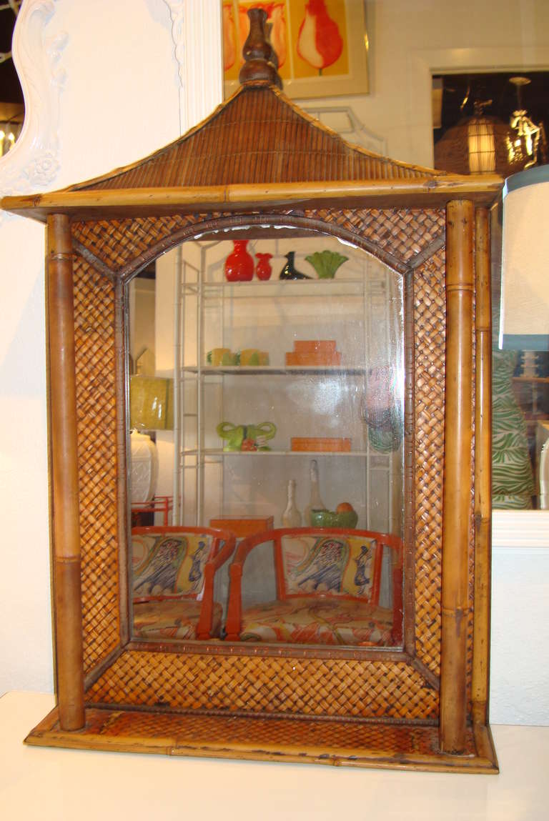 Mid Century Pagoda Rattan and Bamboo Mirror Frame with Columns and Shelf
Carved Wood Finial.