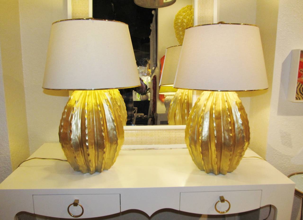 Pair of vintage cactus lamps with gold bordered linen shades. Round gold leaf finial. Newly lacquered soft gold.