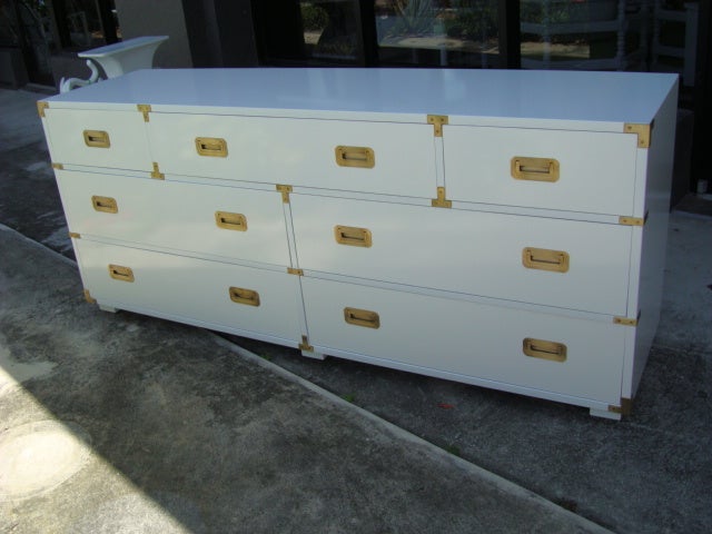 Newly Lacquered White Gloss Campaign Dresser. Burnished Brass Hardware. Fitted Center Drawer.