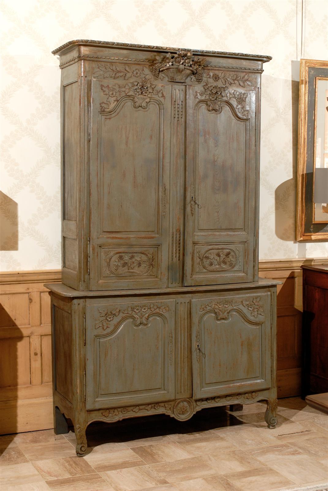 A recently added coat of paint has updated this stately buffet to make it a perfect fit for today's decor. The intricate carving of grapes and basket of flowers, very typical of pieces from Normandy was clearly done by a skilled carver. Some of the