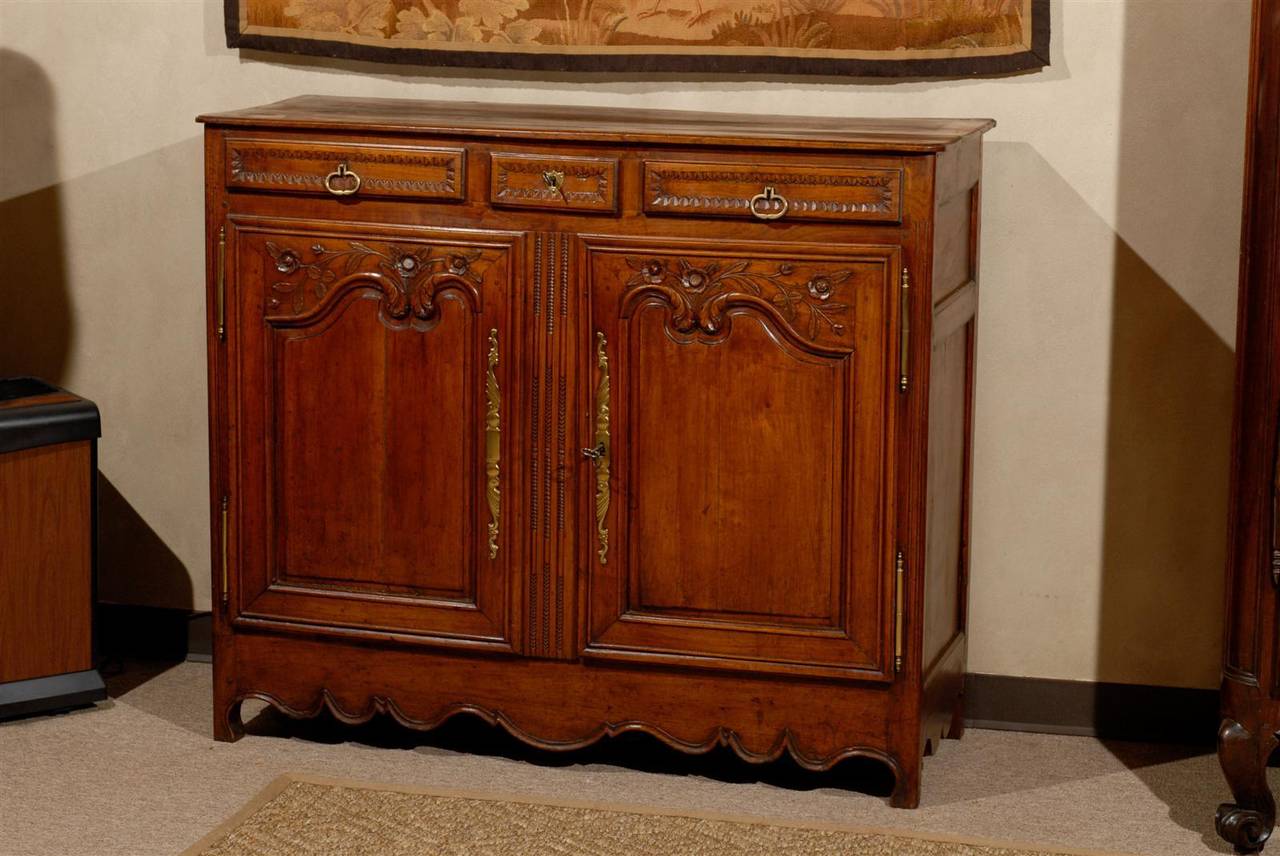 We found this charming buffet in Normandy.  The carving is simple but adds some elegance to a more relaxed piece.  It has been made from the local cherry wood and has very appealing dimensions. It is both tall and narrow.  The depth is 19