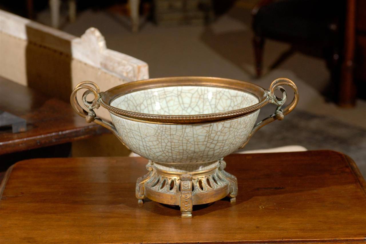 19th Century Chinese Crackleware Bowl with Bronze Fittings, Circa 1875
There are some accessories that seem to enhance any decor and this crackle ware bowl is one of them. Although it is a design used down through the centuries, the soft gray color