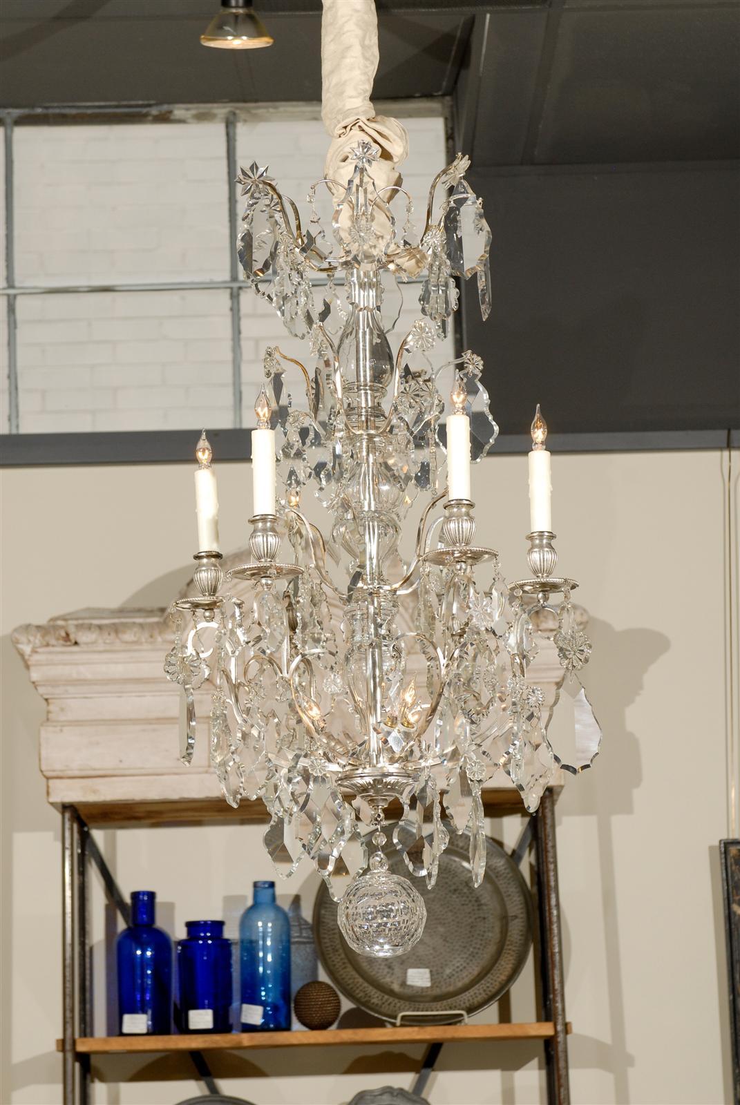 Vintage silvered bronze and crystal chandelier from France, circa 1900.
This chandelier has six arms and three small lights on the base so there can be a lot of light reflected from the gorgeous large crystals and the silvered surfaces of the cage.