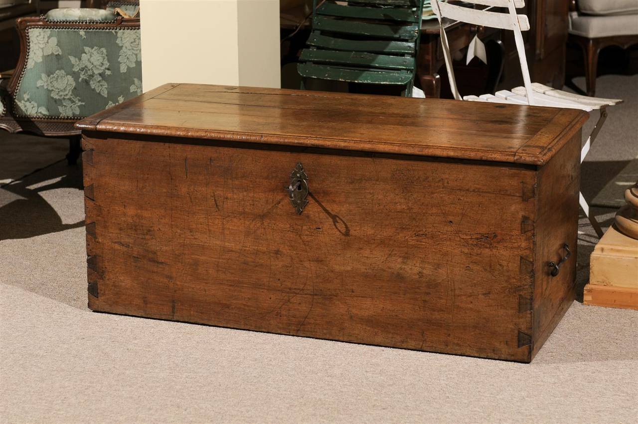 Our French walnut  blanket chest has lots of charm.  It is dove tailed on the sides and has great hardware adorning the front keyhole and the sturdy handles on the side. This useful piece can easily store blankets, games or be used as a rustic