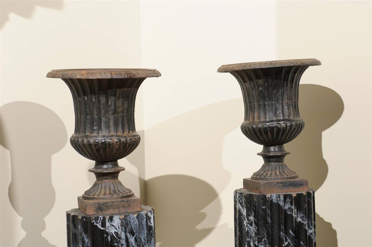 It is easy to see these urns are not the reproductions that are on the market today.  The finish is somewhat irregular with remnants of old rust and chipped places. We find the evidence of age appealing and interesting, just what we look for when we