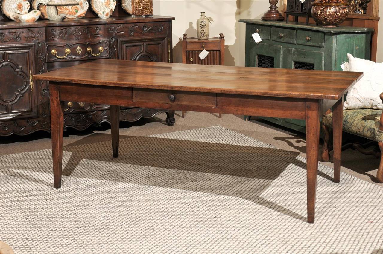 What a gorgeous piece of walnut!  This is truly a beautiful table.  The classic French farm table that you will treasure forever and enjoy your family at the same time.