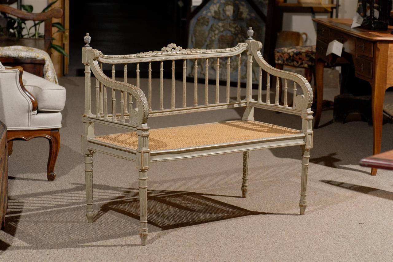 This is a lovely caned seat Louis XVI style bench with carved and painted frame.  It is a very sturdy piece that would look great about anywhere in the house!