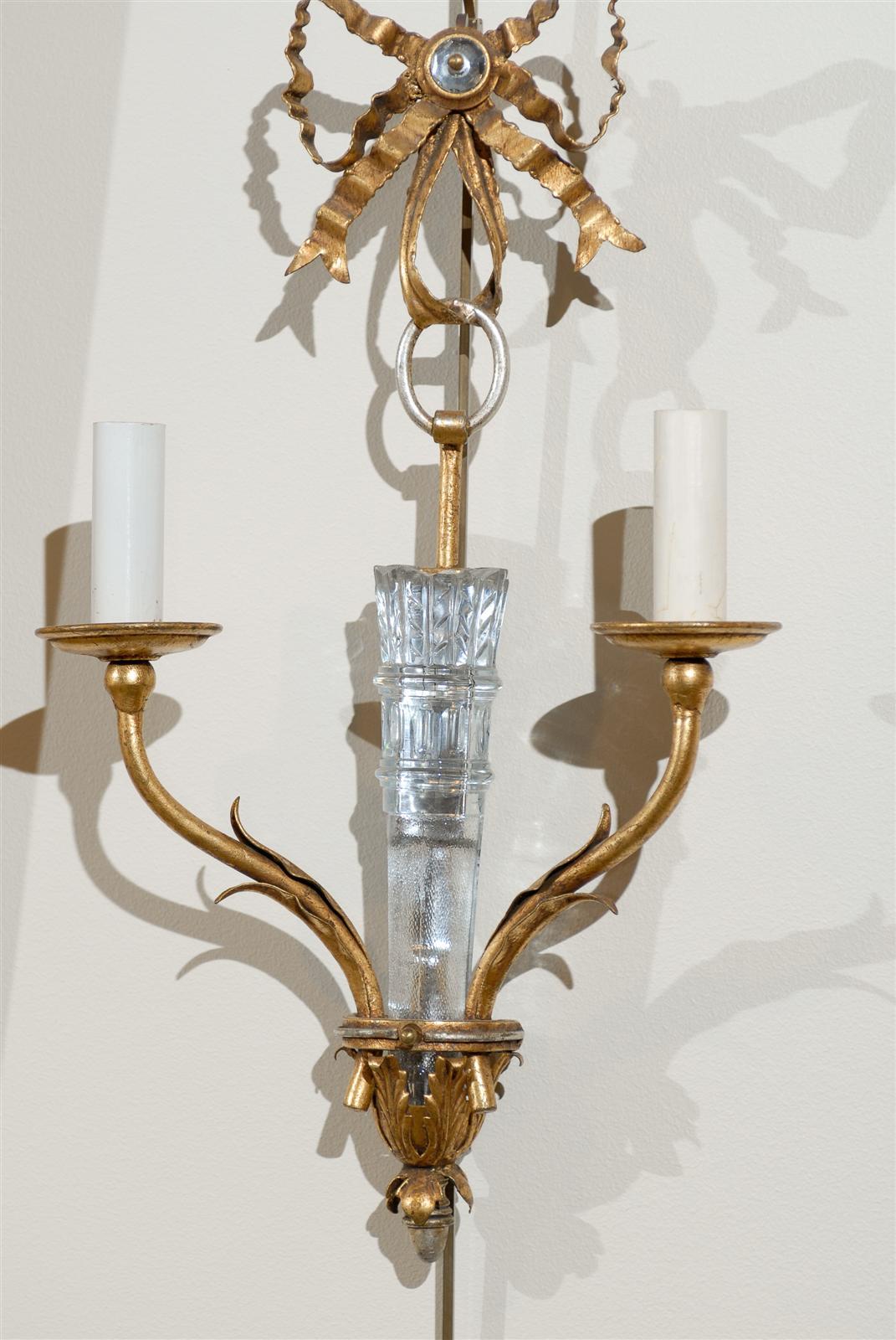Mid Century French Bagues Crystal Sconces, Circa 1940
This stunning pair of French Bagues sconces have a very delicate design.  The bronze bow atop the pair of candlesticks is centered with a crystal that catches the light and compliments the